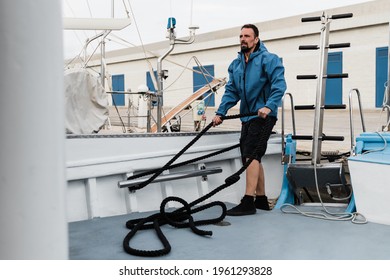 Deckhand worker man working inside boat at ship port - Focus on face