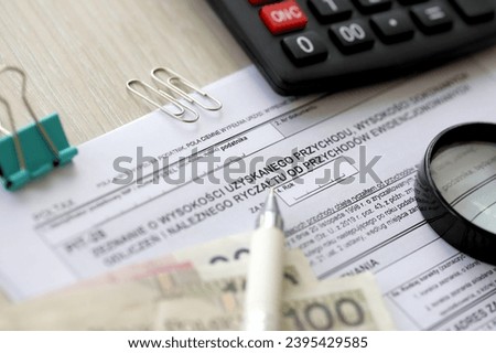 Declaration of amount of income obtained, amount of deductions made and lump sum due from recorded income, PIT-28 form on accountant table with pen and polish zloty money bills close up