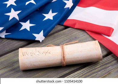 Declaration of the Independence of the United States. Close up vintage constitution of the USA and USA flag on wooden background. Documents of the country. - Powered by Shutterstock