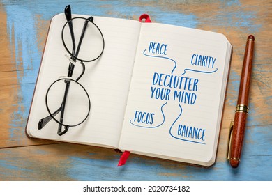 Declutter Your Mind For Clarity, Peace, Focus And Balance - Handwriting In A Notebook Or Journal With Acup Of Tea, Minimalism, Self Care And Personal Development Concept.