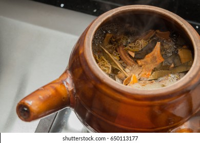 decocting Chinese medicinal herbs with enamel pot - Shutterstock ID 650113177