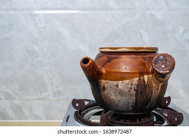Decoction of a medicine jar on a kitchen stove - Shutterstock ID 1638972487