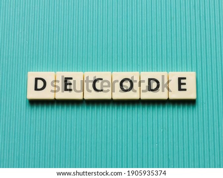 DECODE word made from square letter tiles on turquoise background.