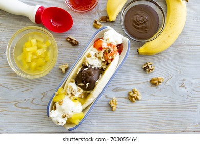 Deconstructed Banana Split Ingredients On Rustic Wood.