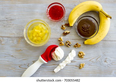 Deconstructed Banana Split Ingredients On Rustic Wood.