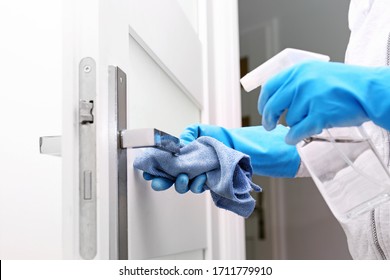 Decontamination against door handles.Prevention and prevention of infection. The woman cleans the apartment. - Shutterstock ID 1711779910
