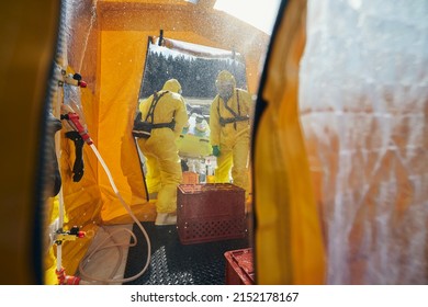 Decontamination of biohazard team of emergency medical service in protective suits. - Shutterstock ID 2152178167