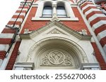 Decor above the portal of the Brasov synagogue Beth Israel, Romania: stone relief on the facade of a brick building. Close-up of the decoration of the Jewish temple in the Hungarian Secession style