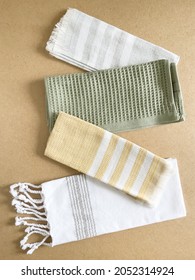 Decor for cozy home. Beautiful kitchen towels made from natural materials are beautifully laid out against beige background. Concept of cute gizmos, home textiles, country style. Top view. Vertical - Shutterstock ID 2052314924