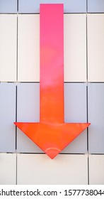 Decor Photo Of A Red Arrow Pointing Down At The Walls Of A Modern Gray Building.