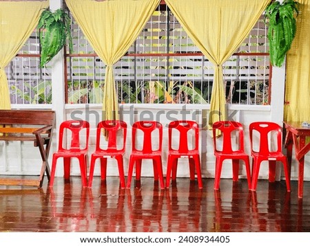 Decorate the balcony of your vacation home with red chairs for photos during Chinese New Year.