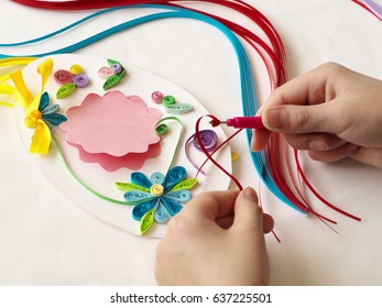 Decorate with strips of paper, quilling .Hands child while creative work making decorations by quilling paper.
