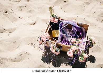 Decorated Box With Champagne, Wine And Glass. Decor Of Flowers On The Sand On The Beach. Place For Text. Close Up. Nature. Style Boho. Party. Maiden Evening Hen-parties. Bachelorette