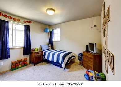 Decorated Boys Room Interior With Blue Curtains, And Stripped Blue Bedding