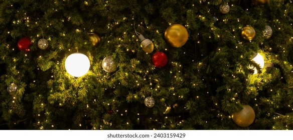 Decorated Christmas tree with lighting and X'mas ball background.