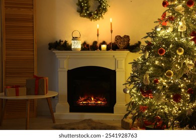 Decorated Christmas tree near fireplace in room. Festive interior design - Powered by Shutterstock