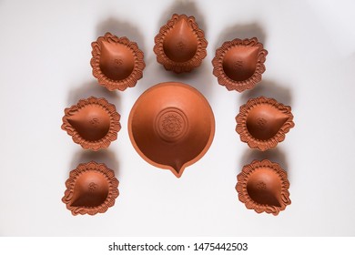 Decorated With Empty Terracotta Oil Lamp On White Background.