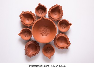 Decorated With Empty Terracotta Oil Lamp On White Background.