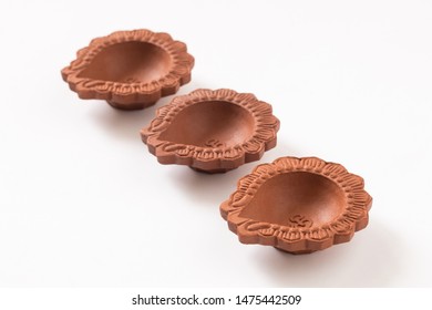 Decorated With Empty Terracotta Oil Lamp On White Background.