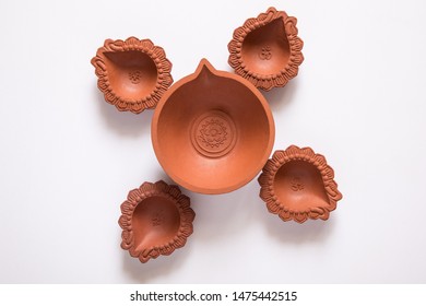 Decorated With Empty Terracotta Oil Lamp On White Background.