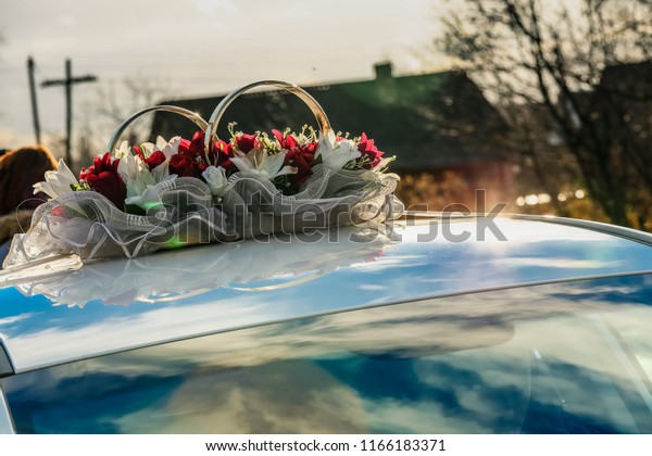 decorated with flowers, rings and elements of\
designer decor wedding car, vehicle exterior, decoration of the\
motorcade and limousine for the newlyweds at the wedding ceremony,\
love and the bride\
