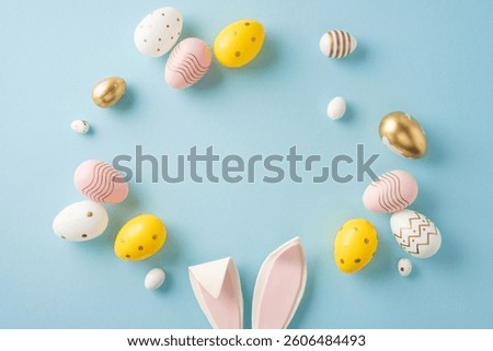Decorated pastel-colored Easter eggs form a circle with bunny ears on a blue backdrop