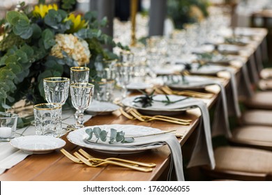 Decorated plate with fork and spoon. Table set up in boho style with pampas grass and greenery - Powered by Shutterstock