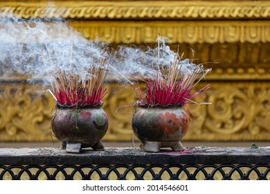 Decorated pots of incense sticks in a Buddhist temple in Bago, Myanmar