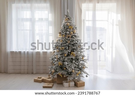 Decorated snowy christmas tree with gifts for new year