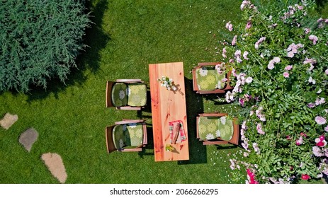 Decorated Table With Cheese, Strawberry And Fruits In Beautiful Summer Rose Garden, Aerial Top View Of Table Food And Drinks Setting Outdoors From Above. Leisure And Picnic With Family And Friends