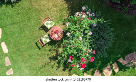 Decorated Table With Cheeses, Strawberry And Wine In Beautiful Rose Garden, Aerial Top View Of Romantic Date Table Food Setting For Two From Above