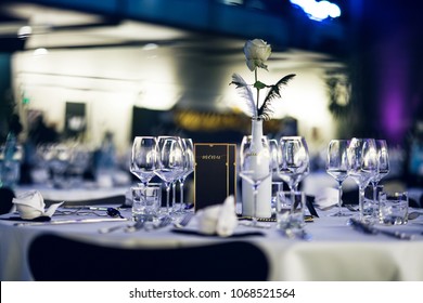 Decorated table on a gala dinner party with wine glasses and blurred out background