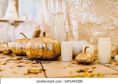 Decorated Table For Wedding. Candles, Autumn Leaves, Confetti, Pumpkins. Autumn Location And Halloween Decor. Setting.