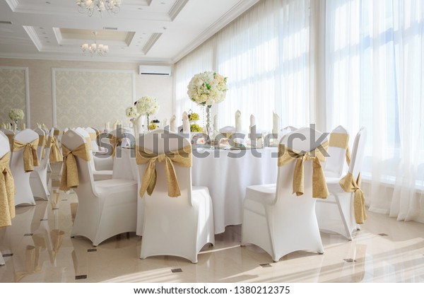 Decorated wedding banquet hall in\
classic style. Restaurant interior for banquet, wedding\
deco