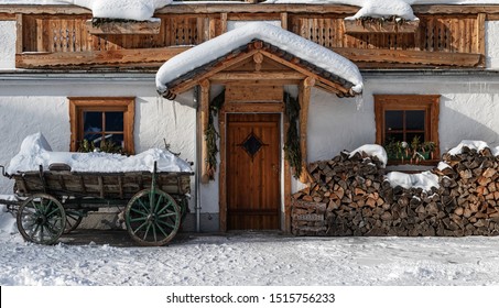 decorated windows and door in the textured wall of a small house in the forest with snow - Powered by Shutterstock