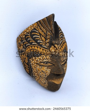 Decorated wooden masks from Java with batik motifs with bird crowns