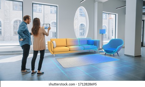 Decorating Apartment: Lovely Young Couple Use Digital Tablet with Augmented Reality Interior Design Software to Choose 3D Furniture for their Home. People Pick Sofa, Table and Lighting for Living Room