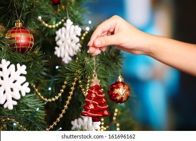 Decorating Christmas tree on bright background - Powered by Shutterstock