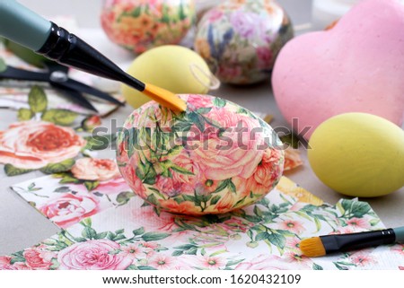 Decorating Easter eggs with decoupage technique. 