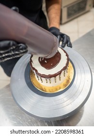 Decorating A Frosted Cake With Chocolate And Nutella