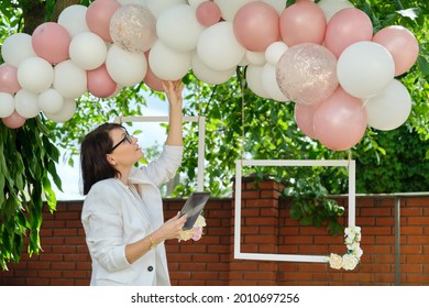 Decorating The Garden With Balloons For A Party, Ceremony