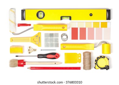 Decorating And House Renovation Tools And Accessories On White Background Top View. Flat Lay Composition In Yellow And Red Colors