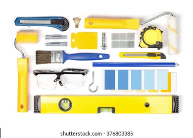 Decorating And House Renovation Tools And Accessories On White Background Top View. Flat Lay Composition In Yellow And Blue Colors