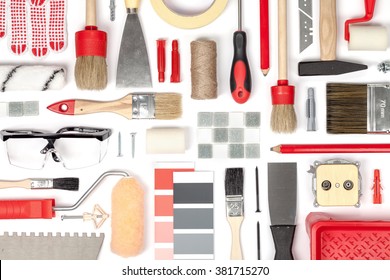 Decorating And House Renovation Tools And Other Essentials On White Background Top View. Flat Lay Composition In Red Colors