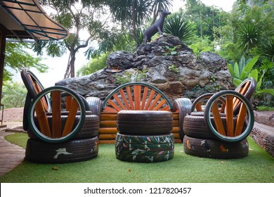 Decorating the old tire wheels as a cup of tea or coffee for copping plants with colorful and warm creative recycling in the garden background - Shutterstock ID 1217820457