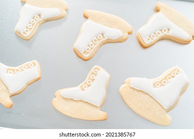 Decorating Sugar Cookies Shaped As Figure Skates With Royal Icing.