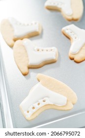 Decorating Sugar Cookies Shaped As Figure Skates With Royal Icing.