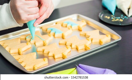 Decorating Unicorn Sugar Cookies With Multi-color Royal Icing.