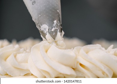 Decorating A White Cake With Cream From The Pastry Bag. Macro Shot, Roses.