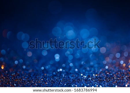 Decoration bokeh glitters background, abstract shiny backdrop with circles,modern design overlay with sparkling glimmers. Blue and golden backdrop glittering sparks with blur effect